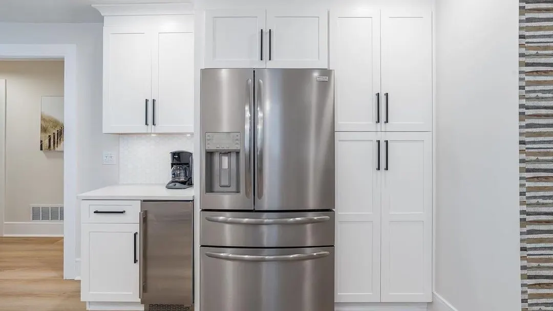 White shaker pantry wall with a built-in refrigerator and coffee station in a remodeled Seacoast NH kitchen